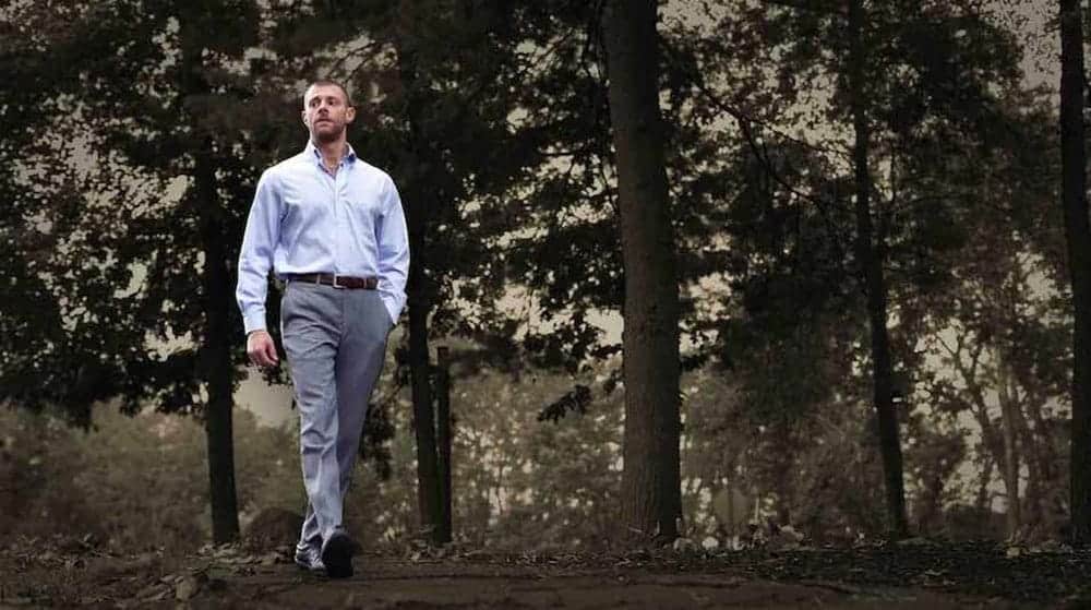 businessman walking through park