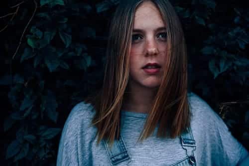 young woman in overalls