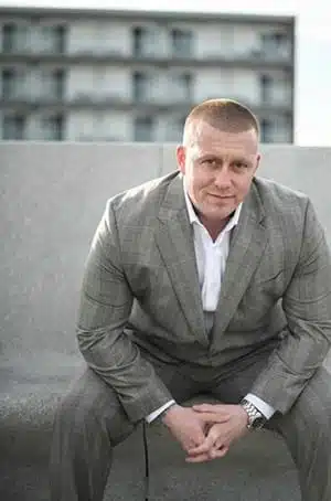 man in suite on rooftop