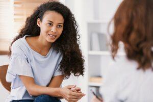 struggling female patient talks to female counselor in a depression treatment program