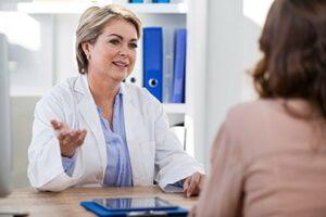 older female doctor talks to female patient about the benefits of gestalt therapy programs