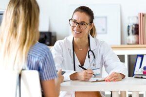 female doctor smiles while talking to a female patient in an opiate detox center