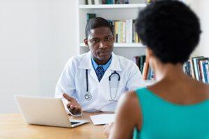male doctor talks about the benefits of a recreational therapy program to a female patient