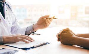 doctor gestures to patient with a pen in a xanax detox center