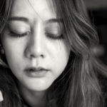 depression and anxiety, black and white close up of woman with eyes closed
