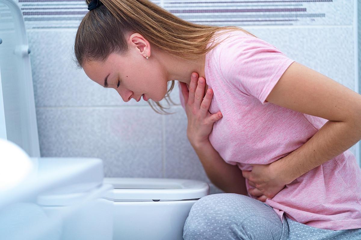drug overdose symptoms, girl leaning over toilet sick