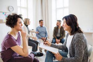 drug rehab program Portsmouth NH, therapist talking with woman in group